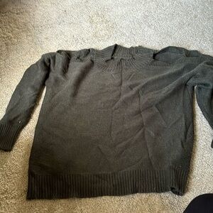 Green sweater with shoulder cutouts